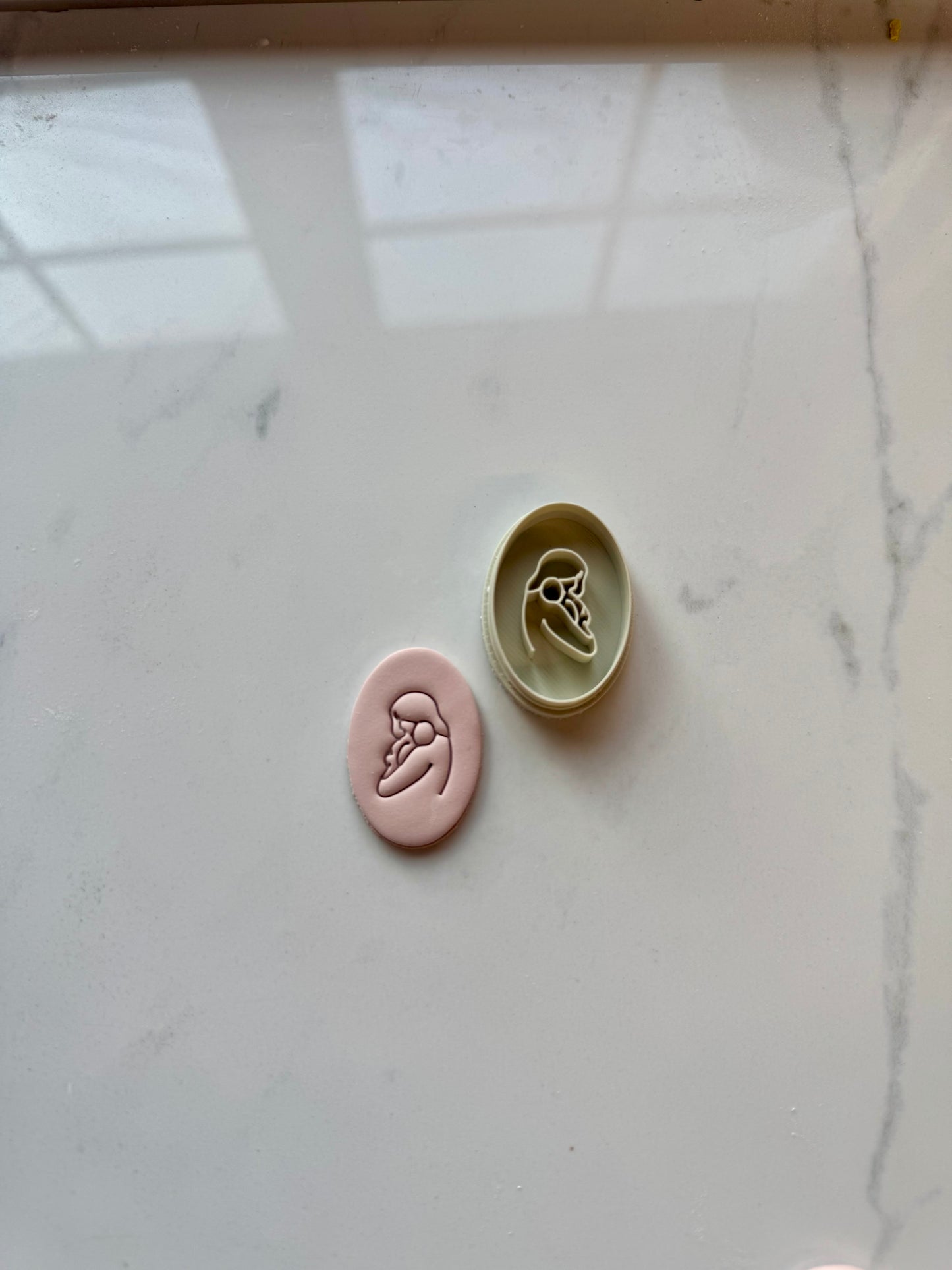 Mom holding baby clay cutter